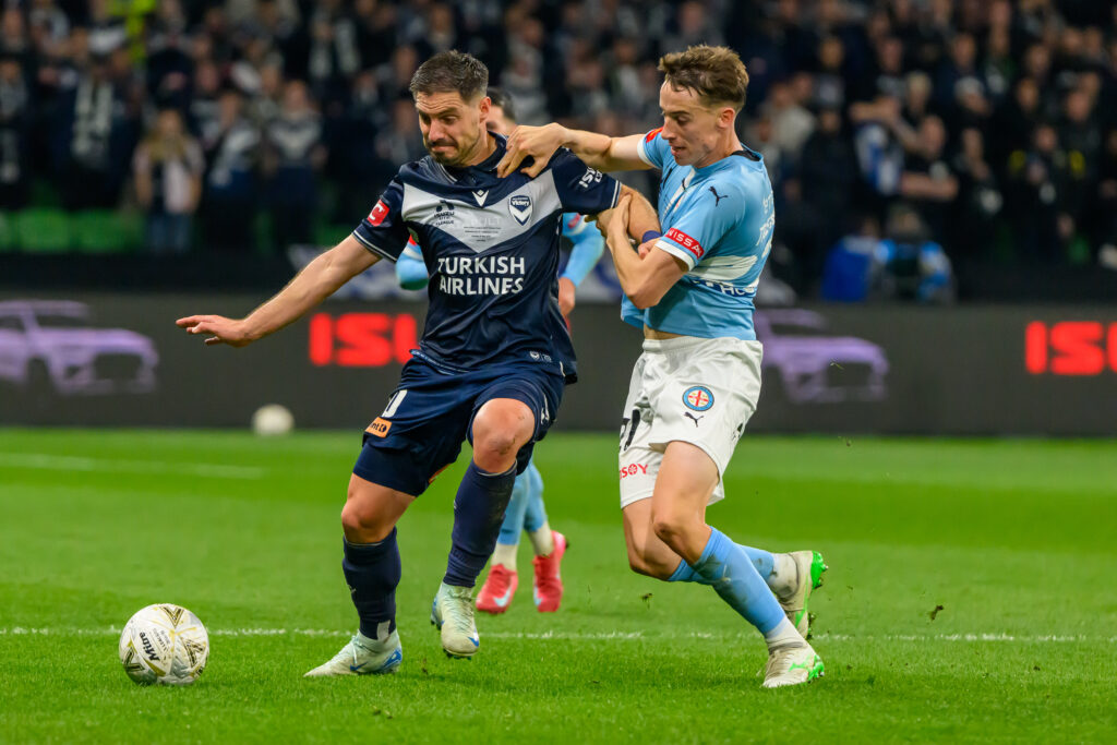 Kai Trewin battling with Bruno Fornaroli during the 2024/25 A-League Men's Grand Final. Photo: Marcus Robertson / Round Ball Australia.
